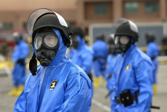 Los Angeles police officers wearing contamination suits secure the area following the explosion of a 'dirty bomb' during a simulated attack at a dock at the Port of Los Angeles.